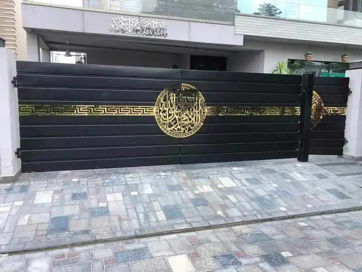 Black steel sliding gate with a gold emblem